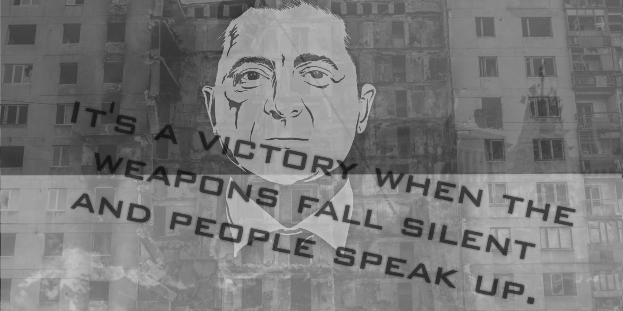 Monochrome mural of a man's face on a damaged building with a quote about victory, silence, and speaking out.