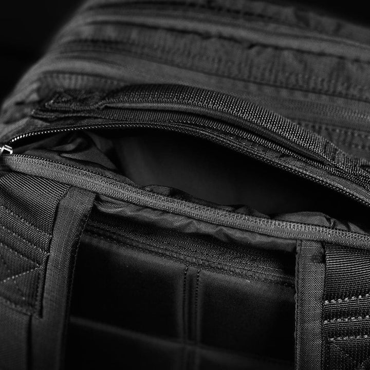 Close-up of an open GORUCK Bullet Ruck Double Compartment in Ripstop Nylon, showcasing its visible zippers and dual compartments.