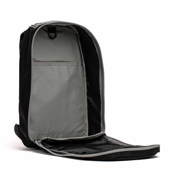 The GORUCK Bullet Ruck Laptop in Ripstop Nylon, available in black and grey, is displayed against a white background, highlighting its water-resistant surface and interior compartments, including a section designed for laptops. Capacity: 16L.