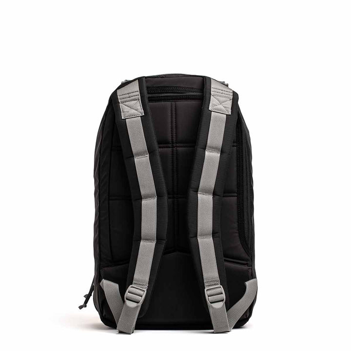 The GORUCK Bullet Ruck Laptop in Ripstop Nylon (16L), a water-resistant backpack in black with gray straps, features a dedicated laptop compartment and enhanced lumbar support, displayed from the back against a white background.