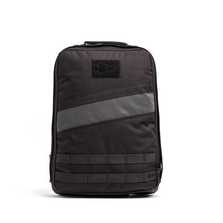 The GORUCK Rucker 4.0 is a stylish black backpack with a minimalist design, highlighted by a diagonal gray stripe on the front. It includes a convenient top handle and several horizontal straps near the base, making it ideal for rucking enthusiasts who value both function and style.