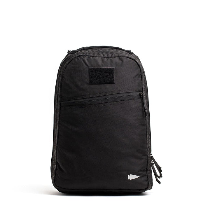 The GORUCK Bullet Ruck Double Compartment in Ripstop Nylon is a stylish black daypack with dual compartments, multiple zippers, and a small logo located on the lower right.