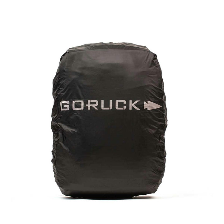 The GORUCK Ruck Rain Cover is a black, lightweight protective cover adorned with the word 'GORUCK' and an arrow logo in white. It serves as a durable waterproof rain cover, providing excellent protection for your backpack against the elements.