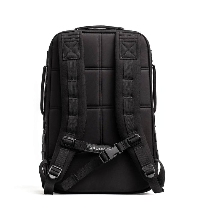 The Rucker 4.0 by GORUCK is displayed from the back, highlighting its padded shoulder straps, central buckle, and reinforced stitching. The quilted back panel ensures extra comfort during rucking adventures.