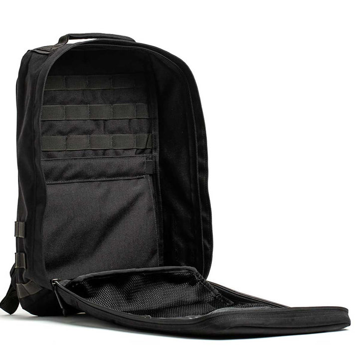 The open black GR1 USA rucksack from GORUCK showcases its spacious compartments and pockets, offering a glimpse of its practical design with 210D CORDURA fabric for durability.