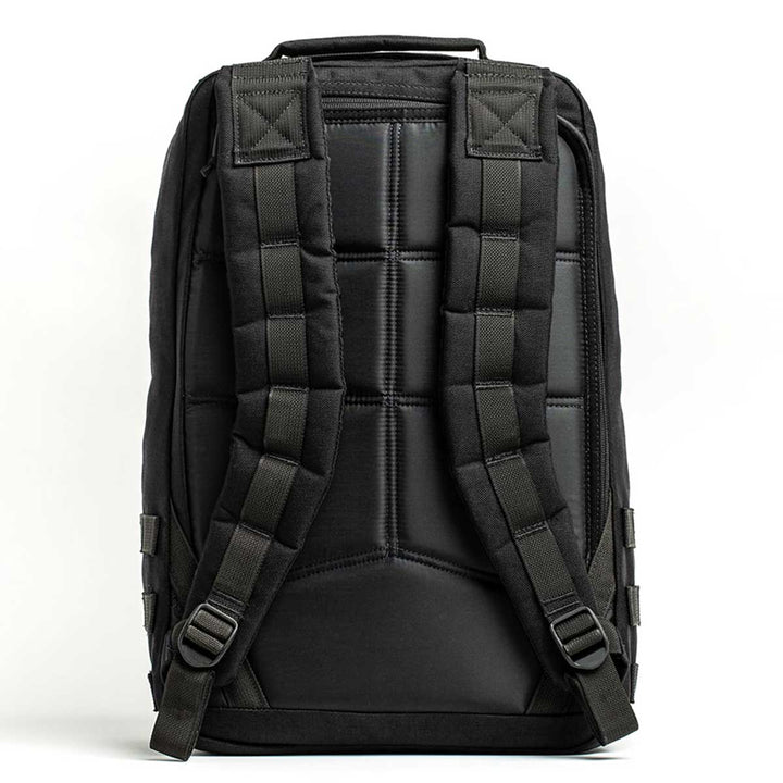 Back view of the GORUCK GR1 USA, a black rucksack made from durable 210D CORDURA, featuring padded straps and stitching details.