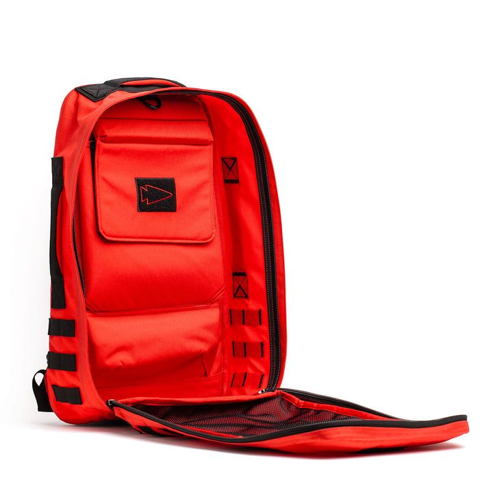 A vibrant red Rucker 4.0 by GORUCK, crafted for rucking adventures, is open, showcasing its meticulously organized interior pockets and compartments.