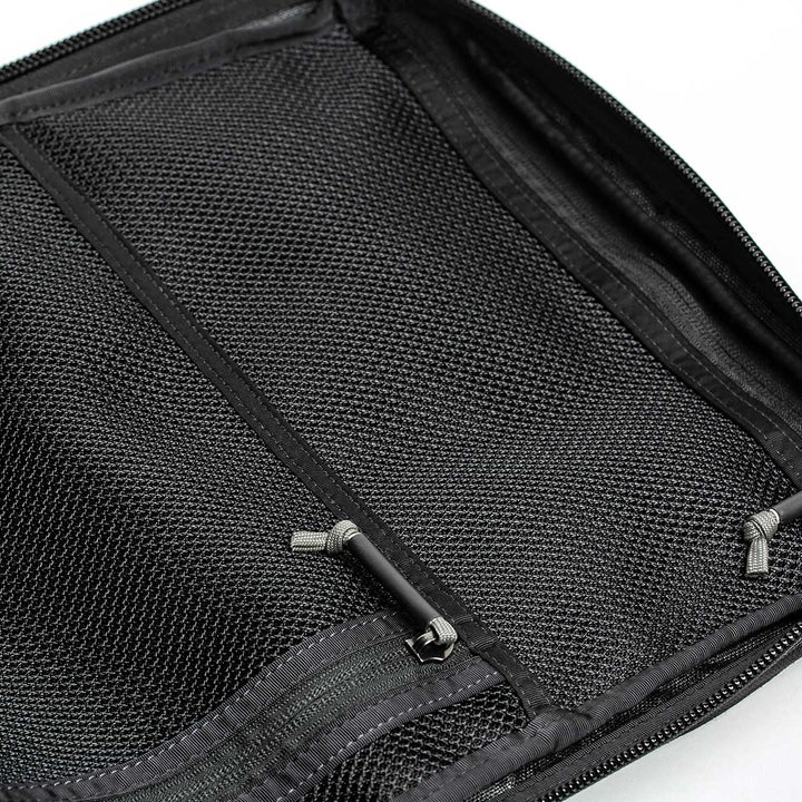 A versatile black mesh zippered pouch, crafted from durable 210D CORDURA®, sits open and empty on a white background, featuring small zipper pulls. The GR2 - USA by GORUCK is perfectly designed to be carry-on compliant, seamlessly complementing your travel essentials with unmatched style and functionality.