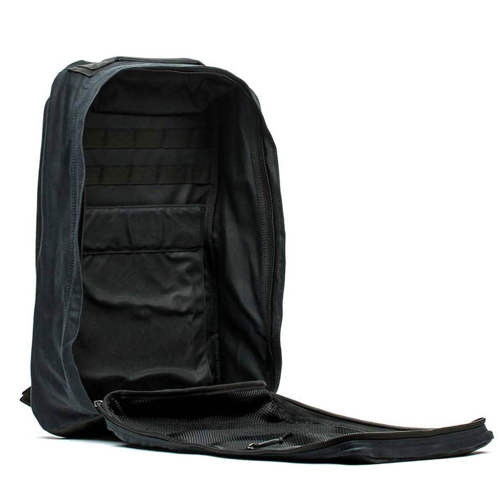 The GR1 USA - Heritage by GORUCK is an open black rucksack showcasing a heritage design with multiple compartments and a fully unzipped front flap, set against a white background.