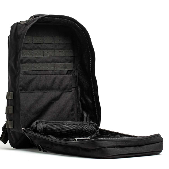 The GORUCK GR2 - USA, shown open against a white background with visible compartments and pockets, is crafted from durable 210D CORDURA®. This backpack is carry-on compliant, combining functionality with style.