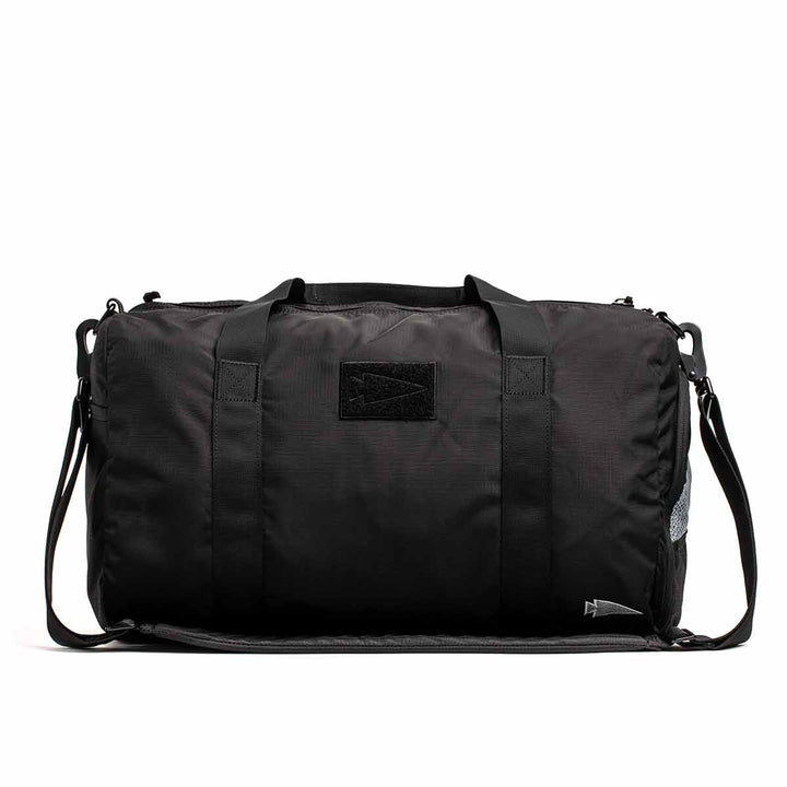 The GORUCK Gym Bag - Ripstop ROBIC® is a stylish black bag that includes handles, a shoulder strap, and a convenient shoe compartment, all beautifully set against a white background.