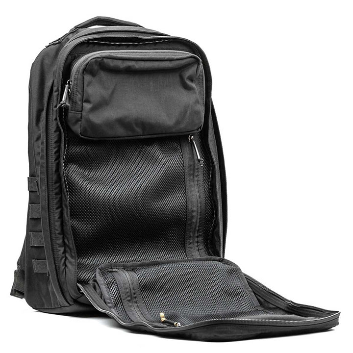 The GR2 - USA by GORUCK boasts several zippered compartments and is slightly open to showcase mesh pockets within. It not only meets carry-on requirements but also comes with the Scars Lifetime Guarantee, promising dependable performance on all your adventures.