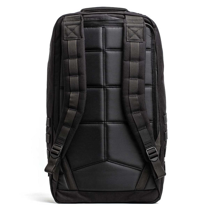 Viewed from the back, the black GR2 - USA rucksack by GORUCK features a padded back panel, adjustable shoulder straps, and side pockets. Ideal for travel with its carry-on compliant design, it comes with a Scars Lifetime Guarantee for lasting reliability.