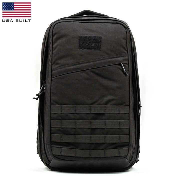 The GR2 - USA by GORUCK is a black tactical rucksack featuring a USA flag and "USA Built" text in the corner. It includes a Scars Lifetime Guarantee, ensuring lasting quality for all your carry-on compliant adventures.