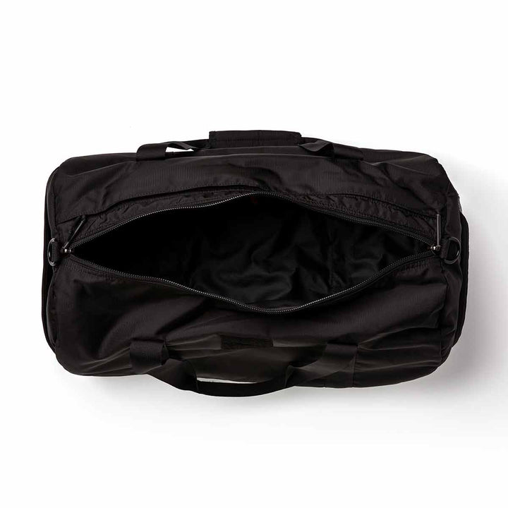 Top view of an open GORUCK Gym Bag - Ripstop ROBIC®, featuring a zipper and handles, crafted from durable black ripstop nylon.