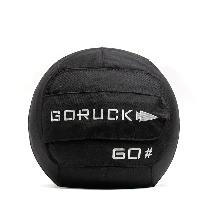 GORUCK Sand Medicine Ball in black, marked with "60#", includes a handle and showcases the brand's arrow logo. Ideal for improving core stability in your home gym.