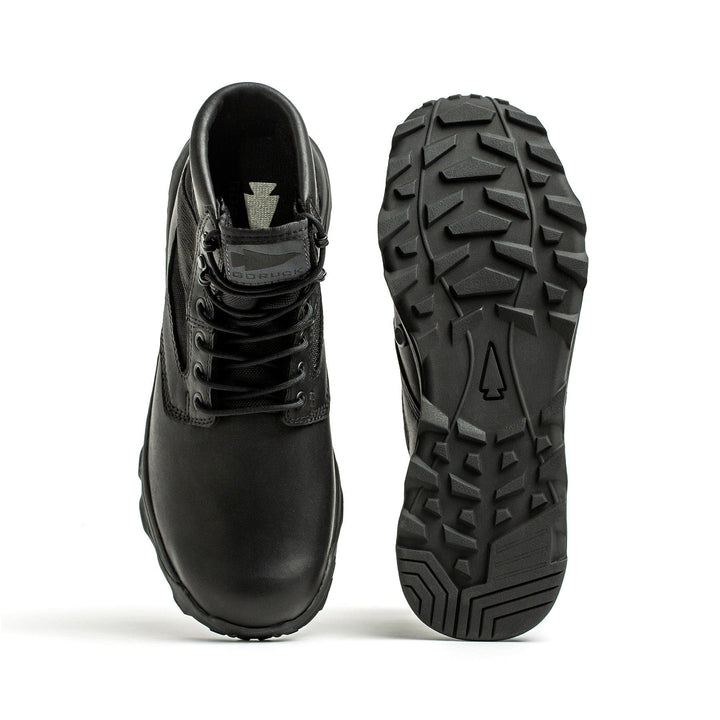 A pair of MACV-2 Mid Top boots by GORUCK in black, one positioned upright to showcase its lace-up front and the other angled to highlight its durable triple compound outsole. Both boots are set against a pristine white background.