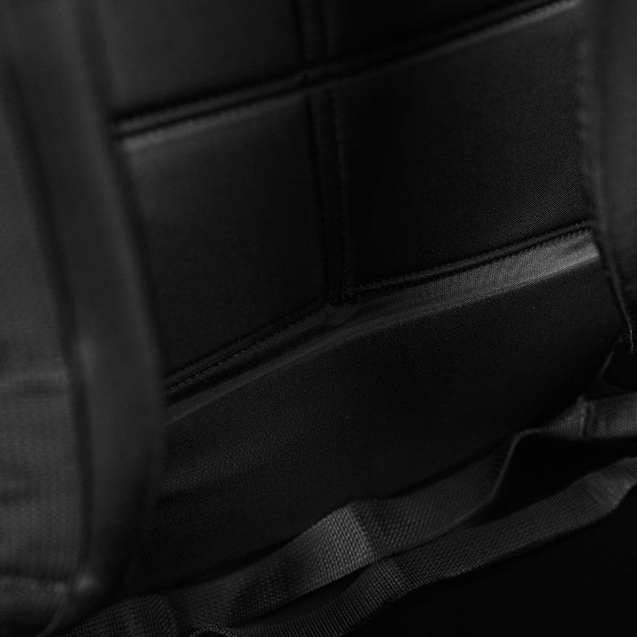 Close-up of the GORUCK Bullet Ruck Double Compartment's padded interior, showcasing its intricate stitching and dual compartments crafted from durable ripstop nylon with sturdy straps.