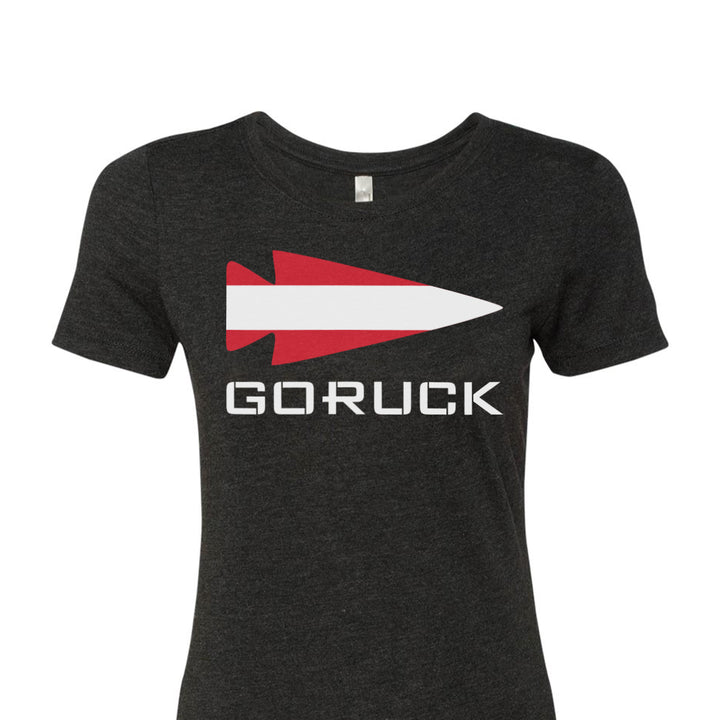 Introducing the Women's T-shirt - Rep Your Country by GORUCK EU, a classic black tee highlighted with a striking red and white arrowhead design and "GORUCK" prominently displayed on the front. Made from a premium tri-blend fabric, it ensures maximum comfort and style.