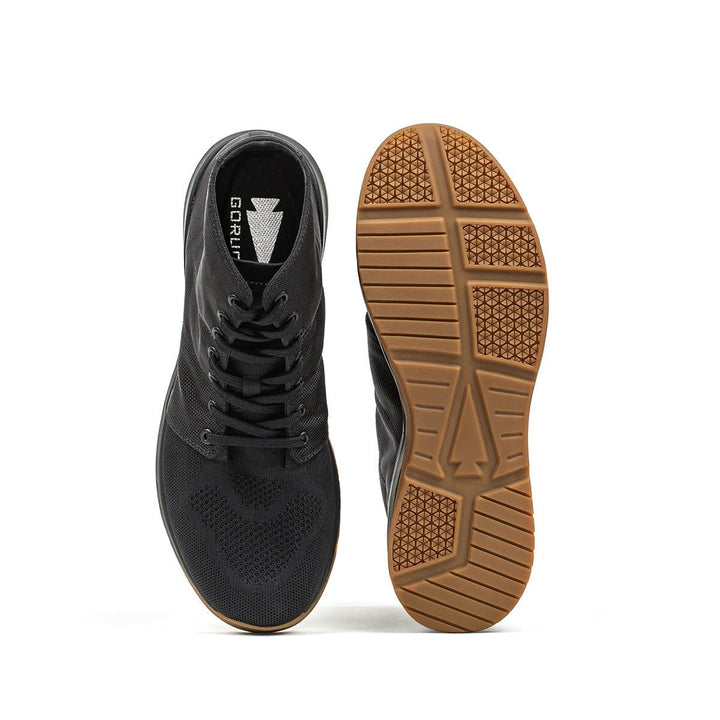 The GORUCK Ballistic Trainers - Mid Top in Black + Gum are crafted with CORDURA® Ballistic Nylon for durability and feature a gum outsole. Perfect for functional fitness footwear enthusiasts, they showcase a top and sole view that highlights the advanced 3X Support™ system.