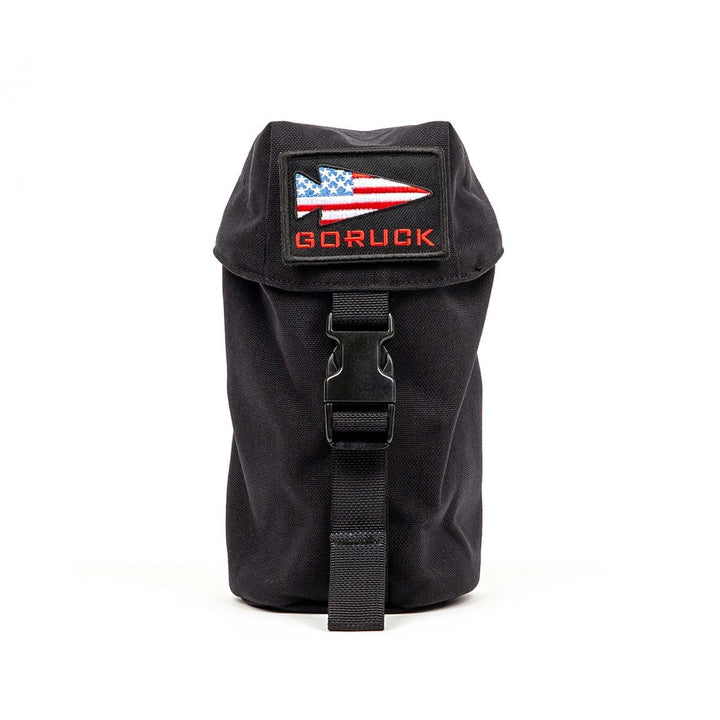 GORUCK's Full Panel Water Bottle Pocket, featuring an American flag logo and buckle strap with a MOLLE attachment system for securing a Nalgene-style water bottle, isolated on a white background.