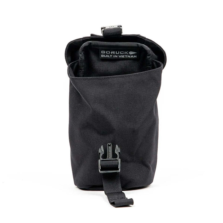 The "Full Panel Water Bottle Pocket" by GORUCK is a black tactical pouch with a buckle closure and a MOLLE attachment system for versatile carrying options. Inside, it proudly displays "GORUCK Built in Vietnam." It also includes a convenient pocket specifically designed to securely fit a Nalgene-style water bottle.