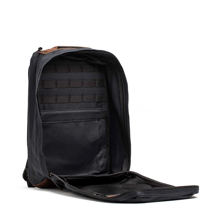 The open GR1 USA - Heritage backpack by GORUCK, made from durable waxed canvas with multiple compartments and a zipper, is displayed against a white background.