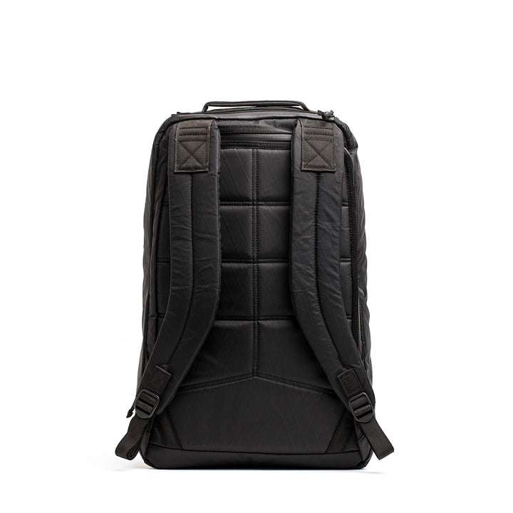 The GORUCK GR1 USA - X-PAC backpack, featuring AquaGuard zippers, padded shoulder straps, and a quilted back, stands upright on a white background.