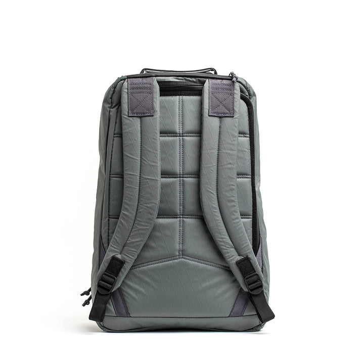 The GORUCK GR1 USA - X-PAC is a gray backpack featuring a quilted pattern, X-PAC material, adjustable shoulder straps, AquaGuard zippers for waterproofing, and a top handle, viewed from the back.