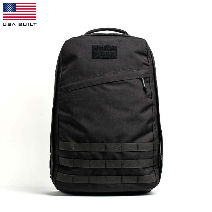 The GR1 USA by GORUCK is a stylish, functional black rucksack with multiple compartments, crafted from durable CORDURA®. It features the USA Built logo and flag in the top left corner.