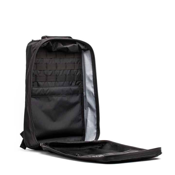 The GR1 USA - X-PAC open black backpack by GORUCK features AquaGuard zippers, multiple internal compartments, and a mesh pocket on the lid.