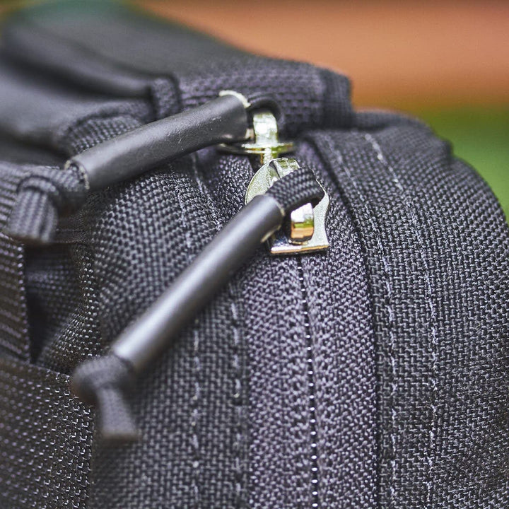 Close-up of the GR1 Field Pocket's zipper from GORUCK, highlighting the detailed stitching and textured fabric, ideal for neatly storing your camera gear.