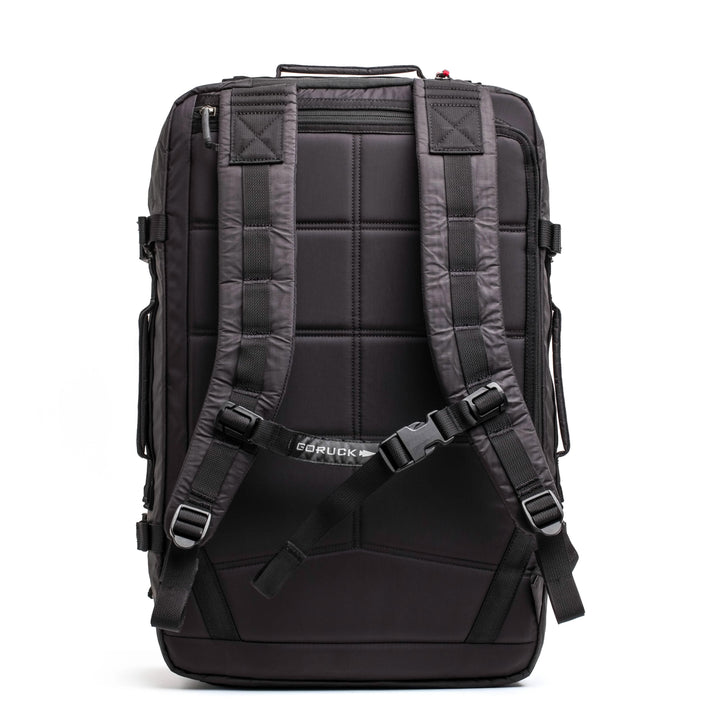 Introducing the GORUCK GR3 - Dyneema: a durable black carry-on backpack designed with padded shoulder straps and a top handle. It is constructed from resilient Dyneema material and equipped with a textured back panel for added comfort and endurance. The GORUCK logo is prominently showcased on the back. Rest easy with the assurance of Scars Lifetime Guarantee.