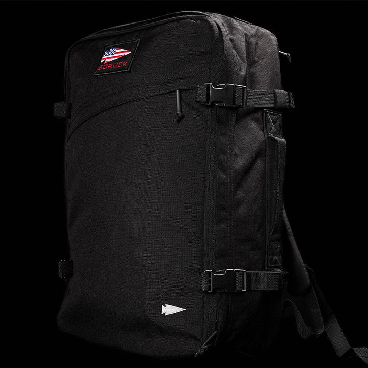 A sleek black GORUCK GR3 - Cordura carry-on rucksack showcases the GR3® logo above an American flag patch. It boasts water resistance, multiple straps, and a minimalist design.