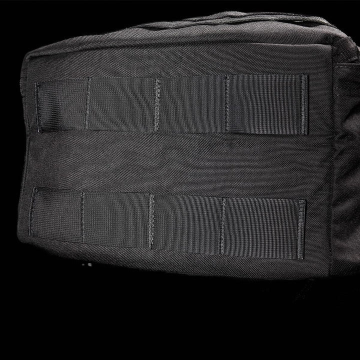 The GORUCK GR3 - Cordura, a black tactical backpack designed for use as a carry-on rucksack, showcases horizontal webbing straps and is made from water-resistant material. Photographed against a black backdrop, it is ideal for both rugged adventures and everyday use.