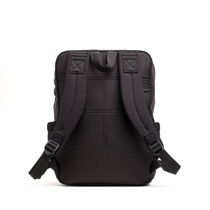 The KR1 2.0 - Kid Ruck by GORUCK is a black backpack designed for kids, featuring padded shoulder straps and a sleek design seen from the back. With reinforced stitching, this durable backpack ensures long-lasting use and resilience for any adventure.