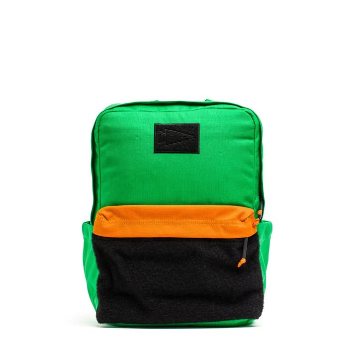 The KR1 2.0 - Kid Ruck by GORUCK is a durable backpack for kids, featuring reinforced stitching. It showcases a green body with an orange and black front pocket set against a white background.