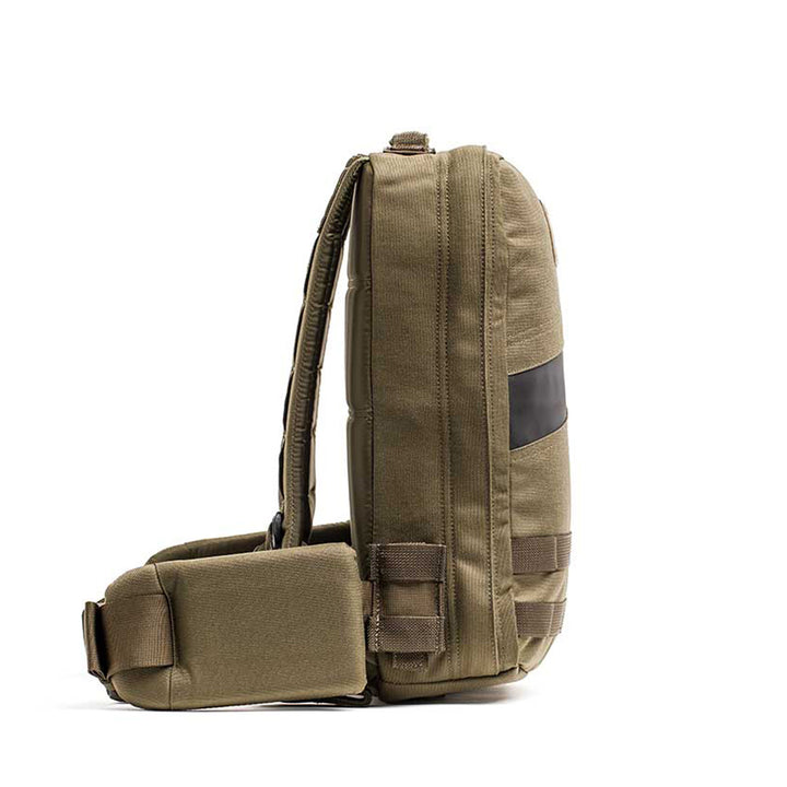 Side view of the GORUCK Rucker 4.0 in khaki green featuring a black horizontal stripe and adjustable straps, ideal for rucking.