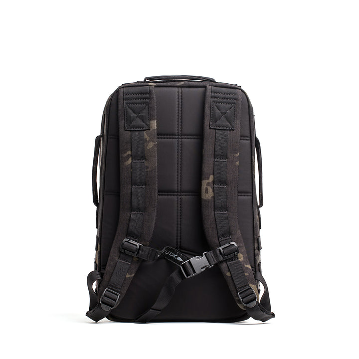 The GORUCK Rucker 4.0 black backpack features padded straps with a subtle camo pattern and a secure buckle, perfect for the gym. It's Ruck Plate compatible to add weights and enhance your workout experience.