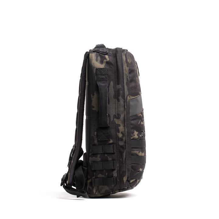 Side view of the GORUCK Rucker 4.0, a camo-patterned backpack that's Ruck Plate compatible, featuring multiple straps on a plain white background.