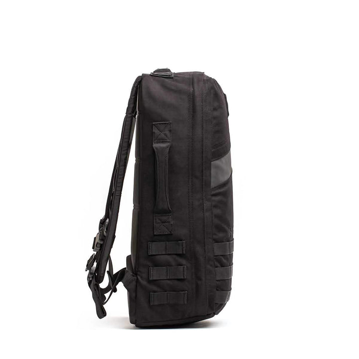 The GORUCK Rucker 4.0 is a sleek black backpack with side handles and adjustable straps, ideal for rucking, shown from the side.