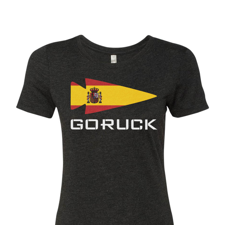 The Women's T-shirt - Rep Your Country, from GORUCK EU, is a premium tri-blend gray garment featuring a striking Spanish flag design next to the word "GORUCK" in bold white letters, seamlessly combining comfort and style to proudly represent your home country.