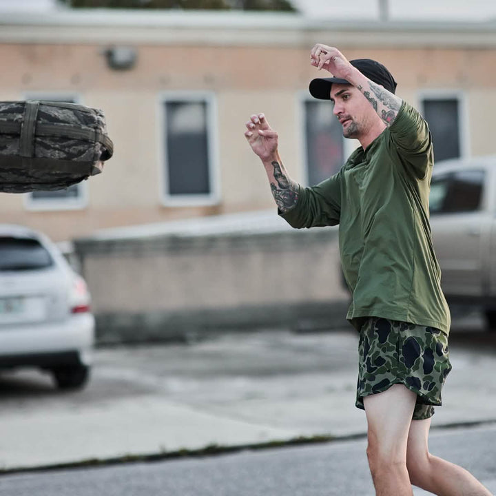 Man working out in Men's Sun Hoodie - ToughMesh in Ranger Green