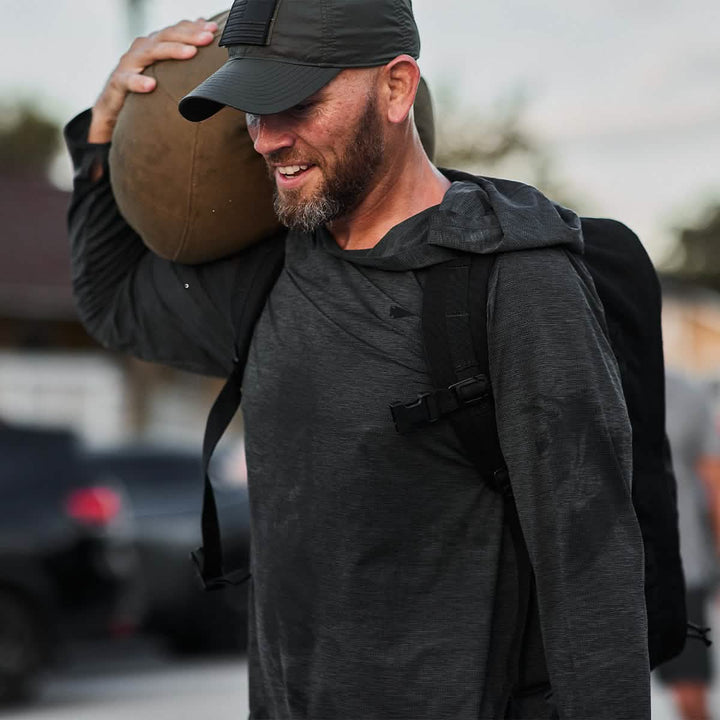 Man smiling while working out in Men's Sun Hoodie - ToughMesh Charcoal