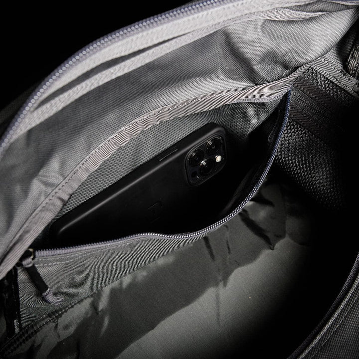 Inside view of a gray GORUCK Kit Bag with a smartphone in an inner zippered pocket.