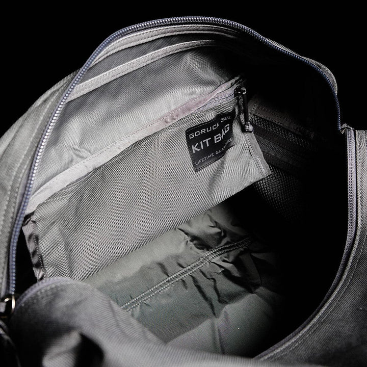 Open the gray Kit Bag from GORUCK, featuring a visible inner pocket and a label that reads "GORUCK Built in the USA KIT BAG." This bag is reminiscent of a Special Forces Flight Bag and is perfect for tough adventures, combining durability and practicality similar to top-notch deployment bags.