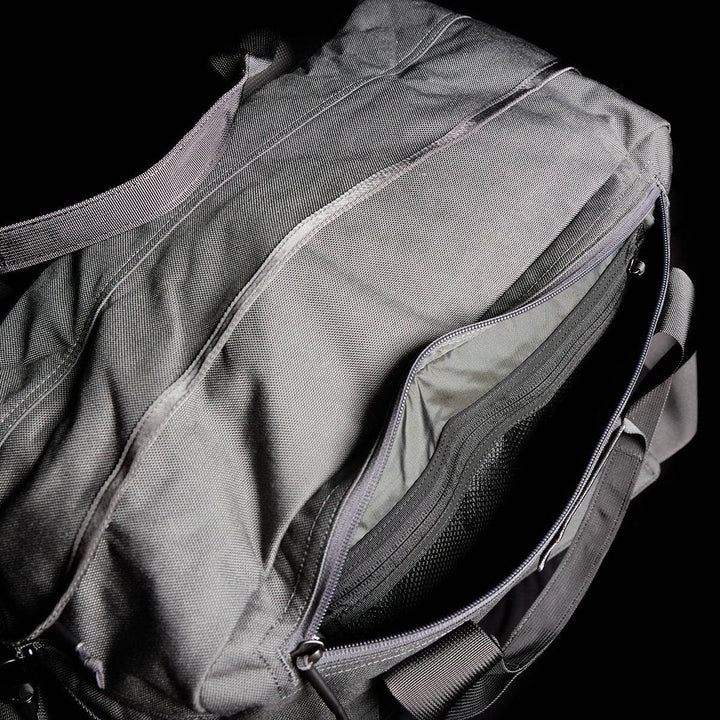 GORUCK's Kit Bag, a gray duffel bag inspired by an Aviator’s Kit Bag design, featuring an open zippered compartment, set against a black background.