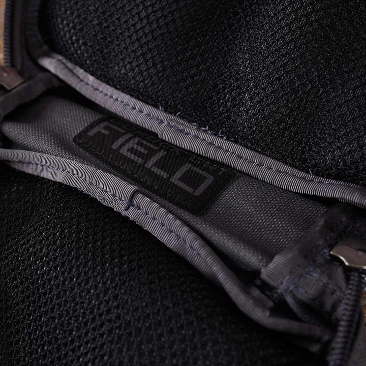 Close-up of the GR1 Field Pocket by GORUCK, featuring a black mesh fabric complemented by a gray strap labeled "FIELD," ideal for organizing your camera gear.