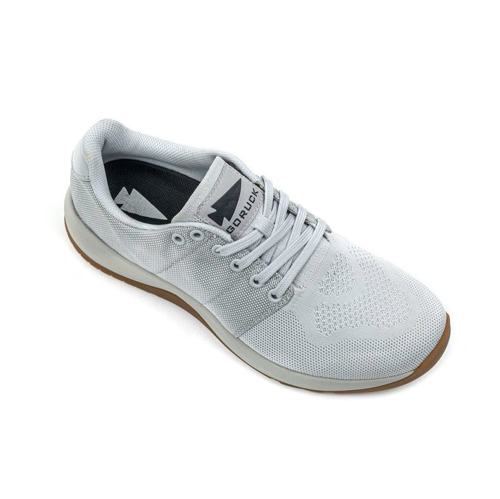 Top view of the GORUCK Ballistic Trainers - Lunar Rock, an athletic shoe in gray with a white sole and laces. It is crafted with durable CORDURA® Ballistic Nylon and features the GORUCK logo on the tongue. This functional fitness footwear incorporates 3X Support™ technology for enhanced stability during your toughest workouts.