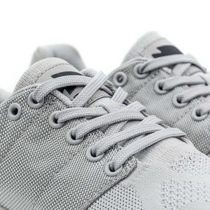 Close-up of gray Ballistic Trainers - Lunar Rock by GORUCK, featuring laces and crafted with CORDURA® Ballistic Nylon, highlighting the texture and design, making them ideal for functional fitness footwear.